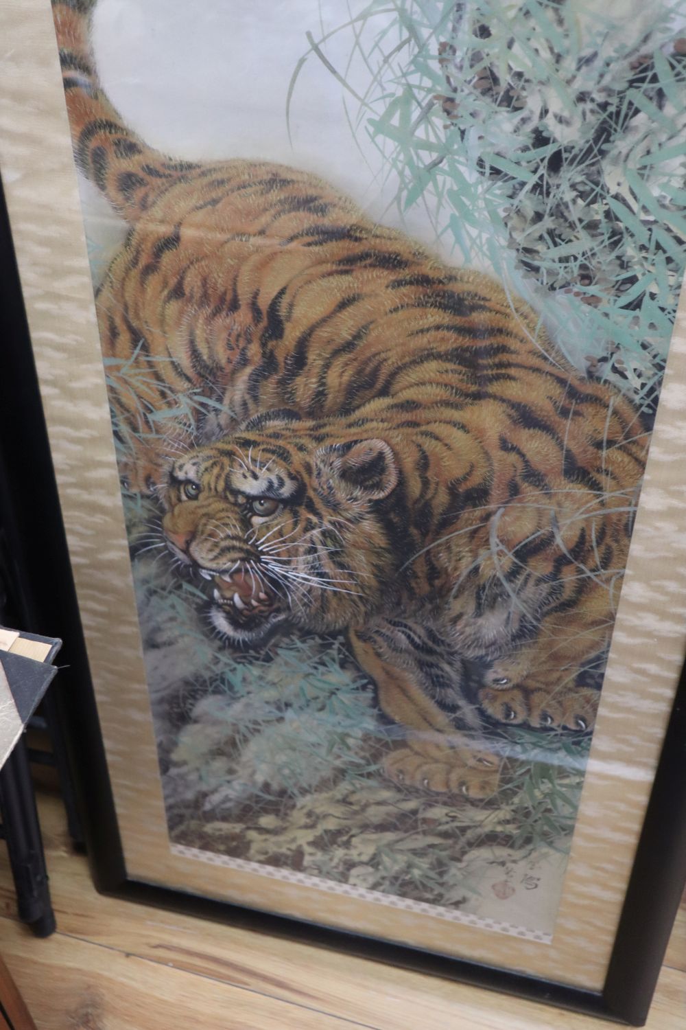 Chinese School (20th century), study of a tiger in a mountainous landscape, watercolour on silk, 125cm x 41cm approx